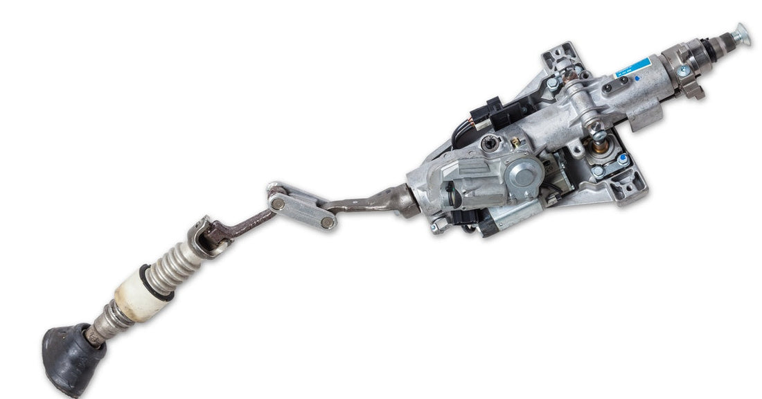 The steering column of a car is laid out by itself, outside the mechanisms of the car. The column features an ignition switch.